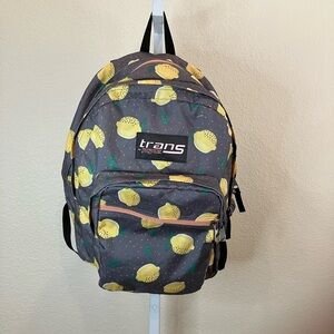 Trans Jansport back pack in yellow lemons on gray background with coral dots.